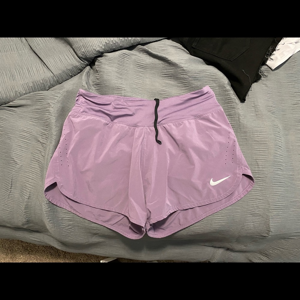 Purple Nike shorts.